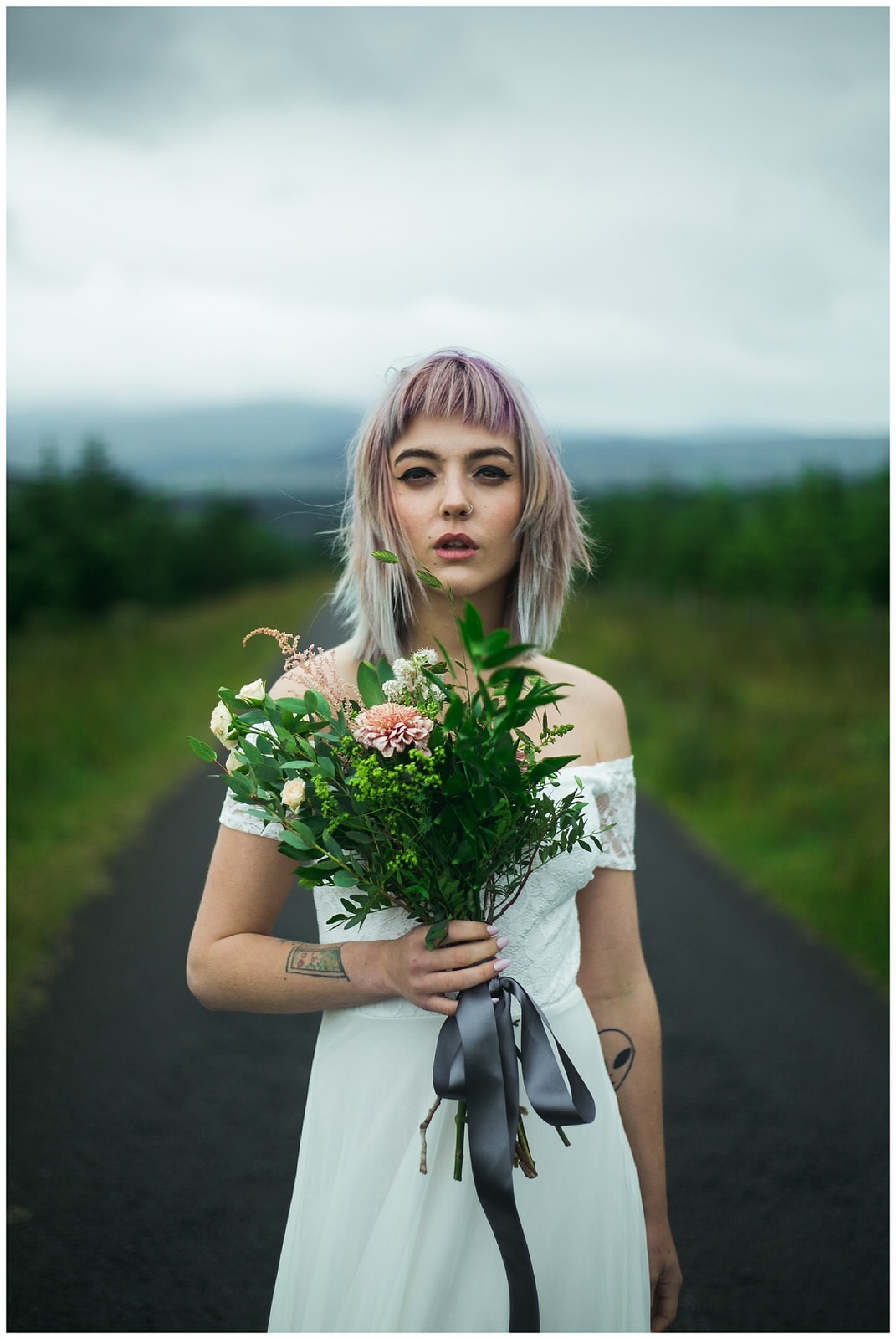 Alternative styled bride holding a wild bouquet - Wild Things Wed Photography 