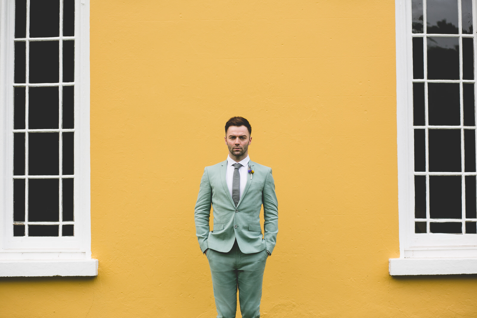 Wes Anderson Wedding with a groom in a pastel green suit