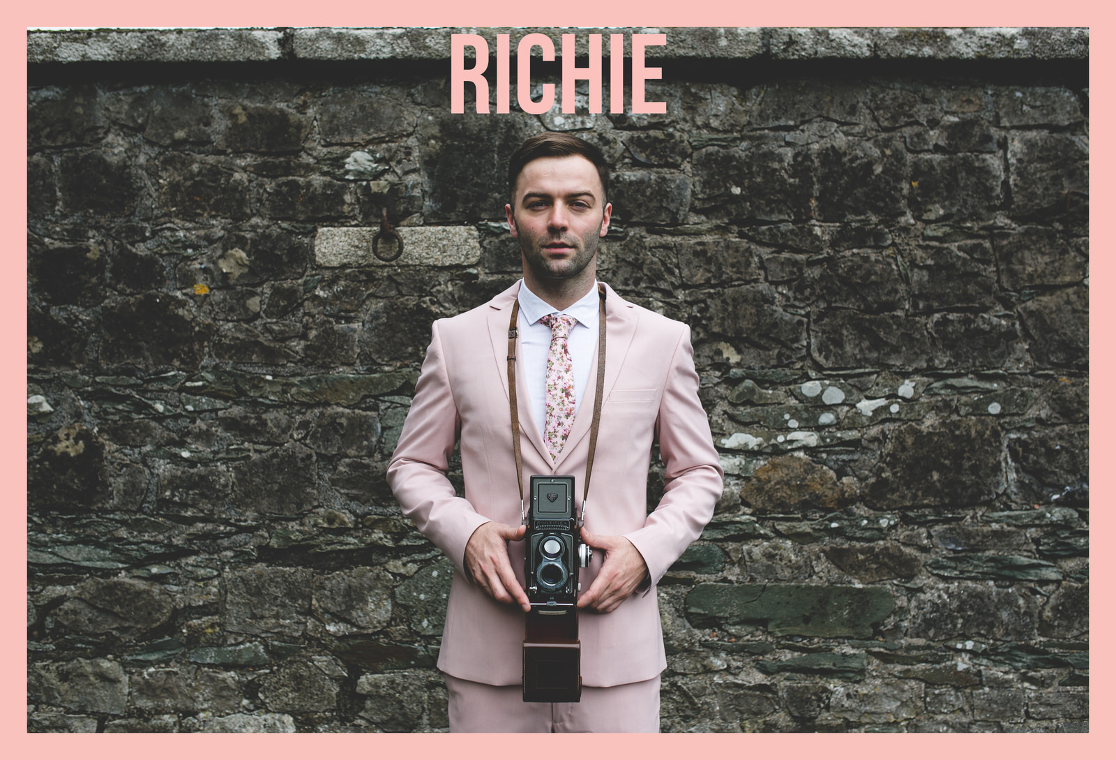 Groom wearing a pale pink wedding suit 