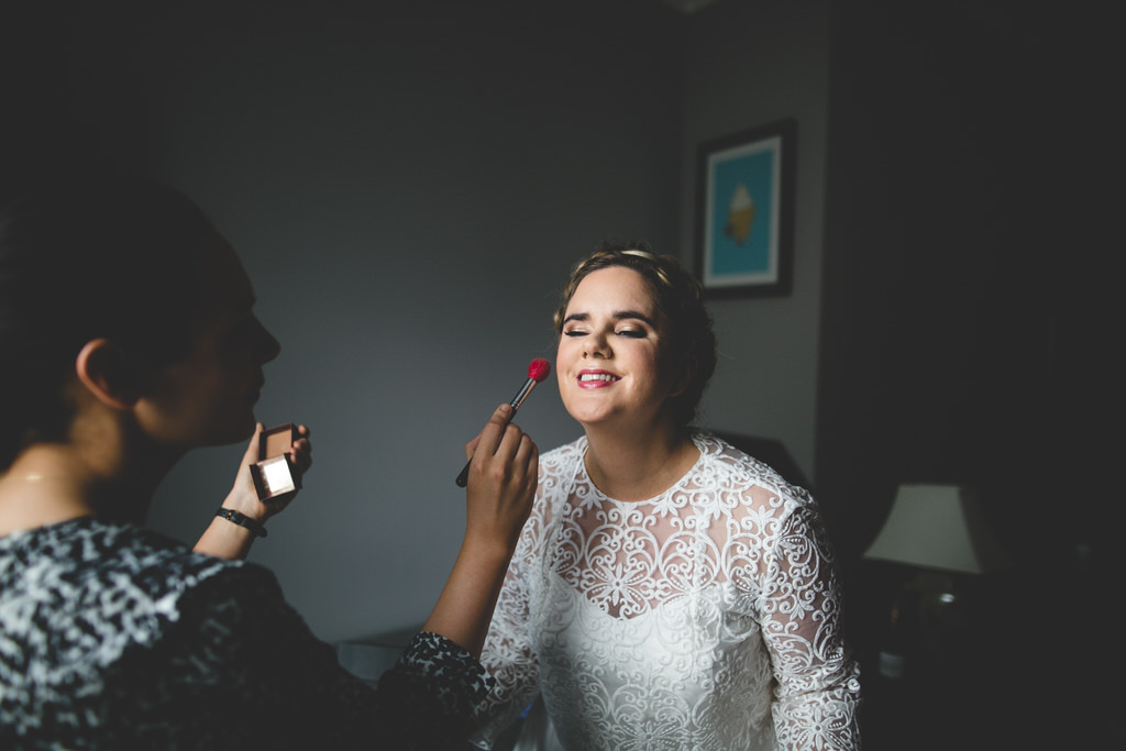 Candid documentary shot of a bride having her make-up done